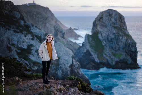 A woman on the Atlantic cliffs near Cape Roca, Sintra, Portugal.