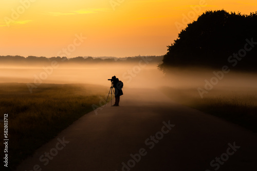 silhouette of a photographer in the sunset