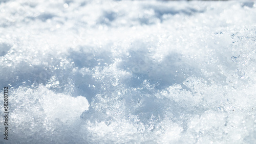 Close-up of snow ice, with intricate patterns and textures. The crisp and clear captures the icy beauty of winter and the natural frozen