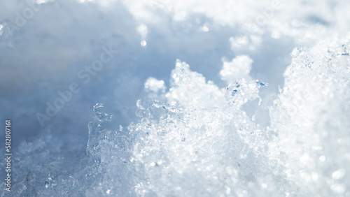 Close-up of snow ice, with intricate patterns and textures. The crisp and clear captures the icy beauty of winter and the natural frozen