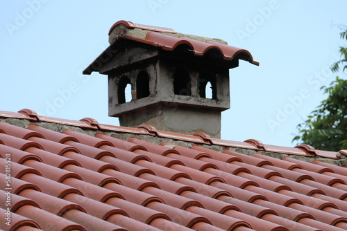 Red tile roof with chimney 