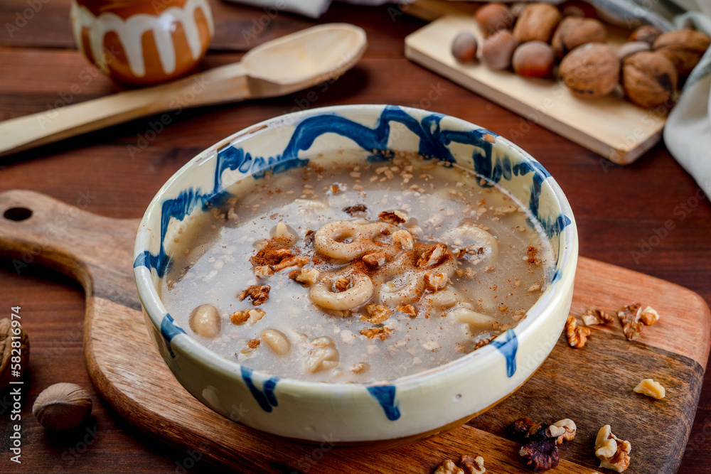 Romania traditional food desert Macinici or Mucenici on traditional plate and dark wood table