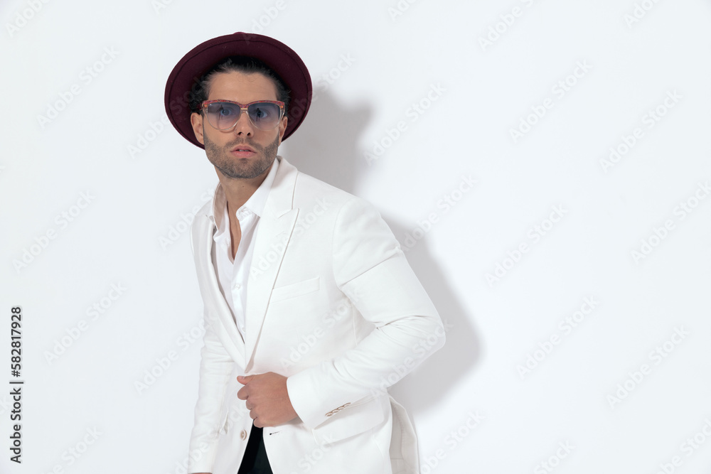 sexy cool man with hat and sunglasses unbuttoning white jacket suit sexy cool man with hat and sunglasses unbuttoning white jacket suit