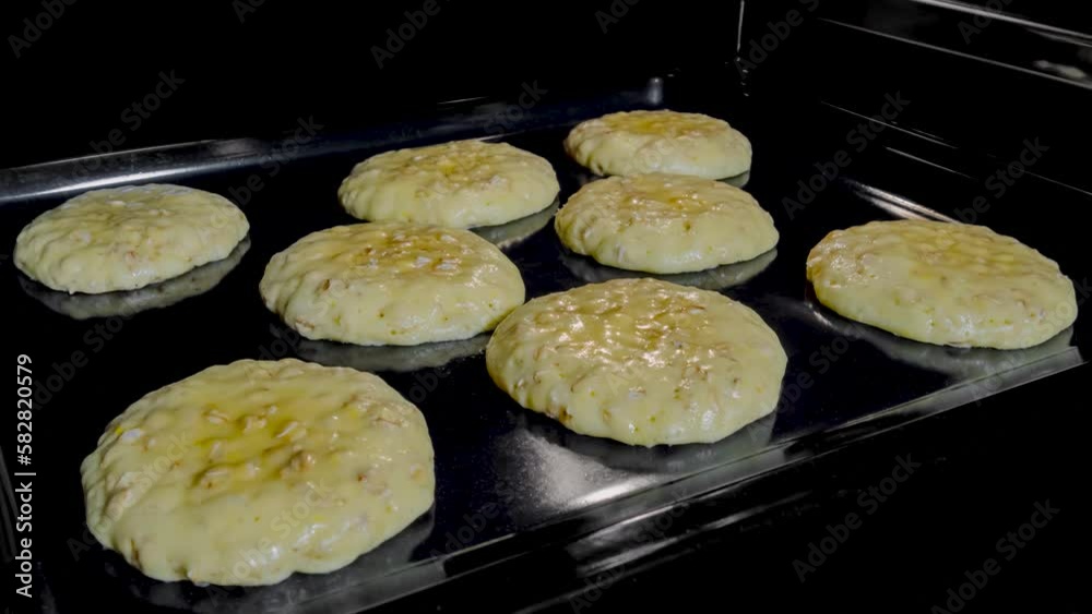 Timelapse - process of cooking eight homemade crunchy oatmeal cookies on metal sheet in oven. Time lapse, dessert, cookery, baking, gastronomy and food concept Timelapse - process of cooking eight homemade crunchy oatmeal cookies on metal sheet in oven. Time lapse, dessert, cookery, baking, gastronomy and food concept