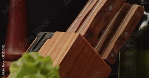 Takes out knife from set to use it, close-up