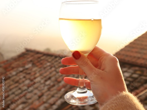 First person shoot of the glass of white wine 