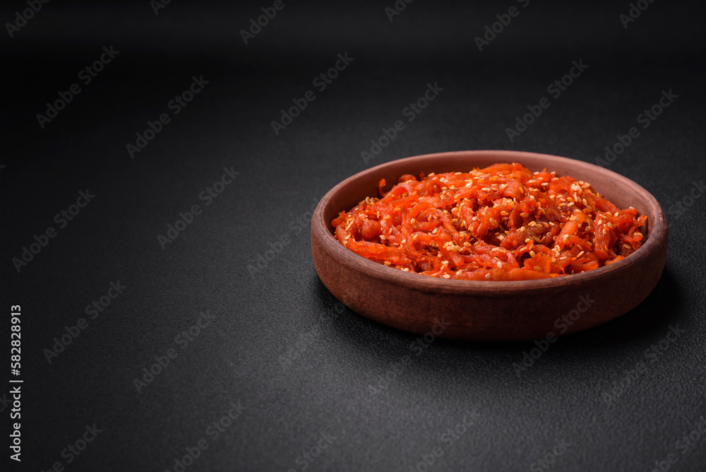 Dried squid chopped into slices and seasoned with sesame seeds and spices Dried squid chopped into slices and seasoned with sesame seeds and spices