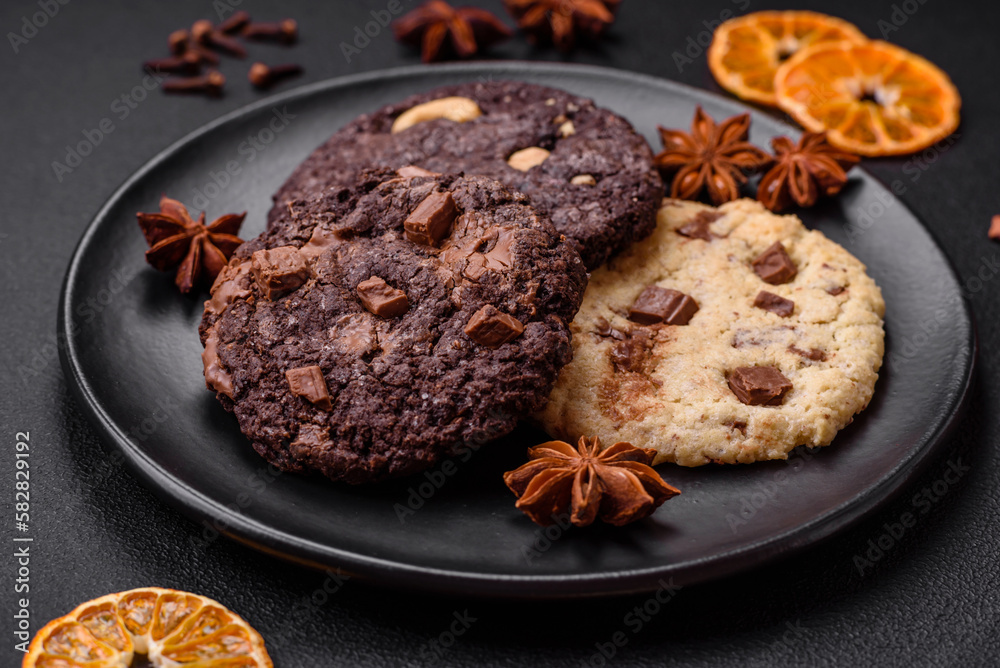 Fototapeta premium Delicious fresh crispy oatmeal cookies with chocolate and nuts