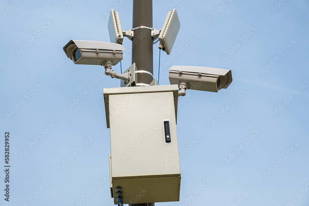Security CCTV camera monitoring system with panoramic view outdoor against blue sky. Safety system Security CCTV camera monitoring system with panoramic view outdoor against blue sky. Safety system