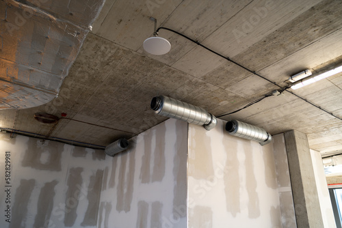 Silencer for circular ducts. Industrial noise reduction from ventilation system in a modern building. photo