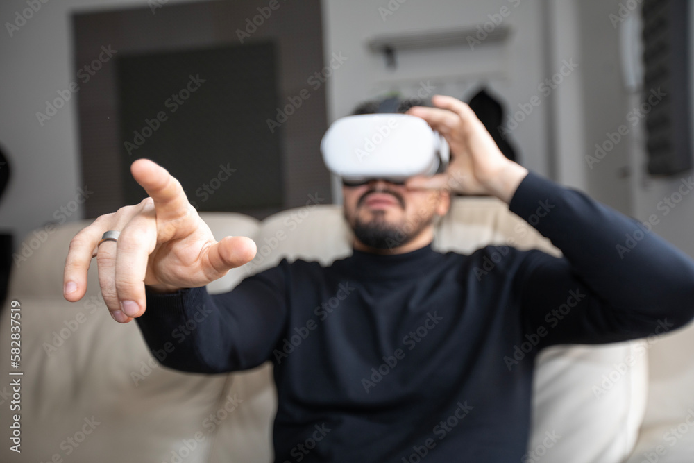 Young man wearing VR Goggles and pointing with finger Young man wearing VR Goggles and pointing with finger