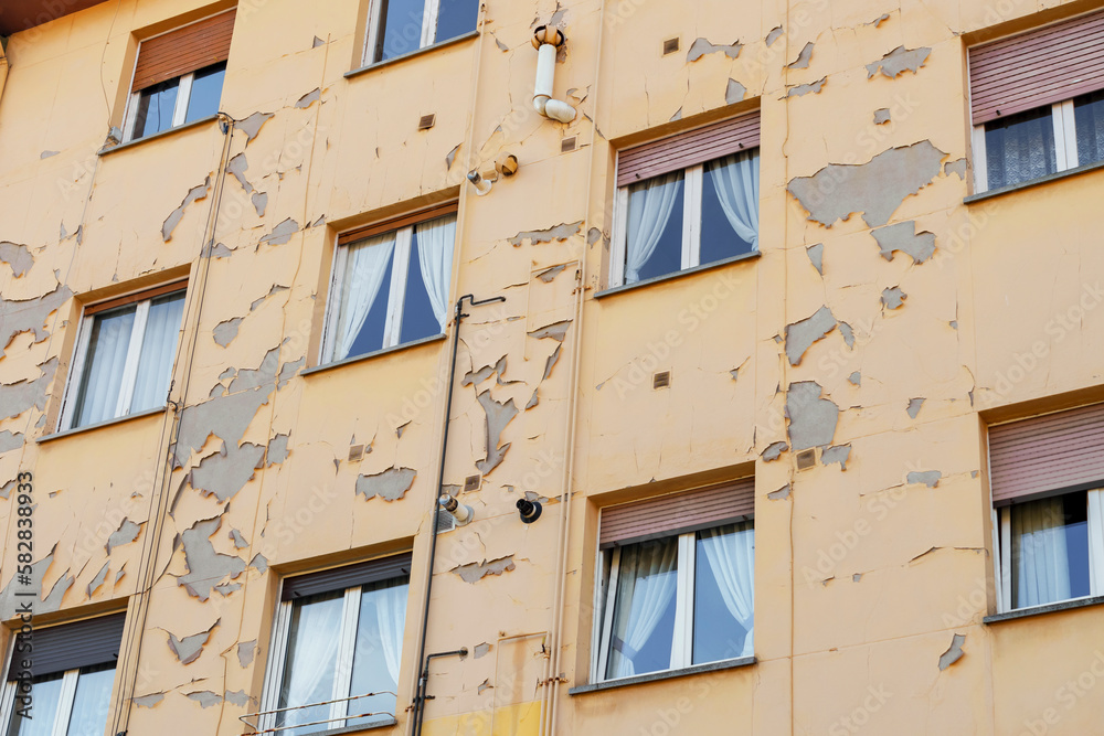 Peeling paint on the wall of a residential building Peeling paint on the wall of a residential building