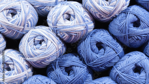 Balls of blue wool, assortment of yarn on display in the store. Sale of yarn for knitting beautiful wool sweaters.