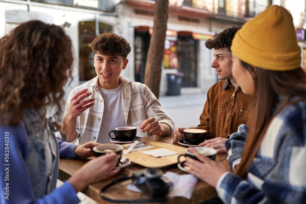 A multicultural group of friends enjoying coffee and tea after their vacation. A multicultural group of friends enjoying coffee and tea after their vacation.