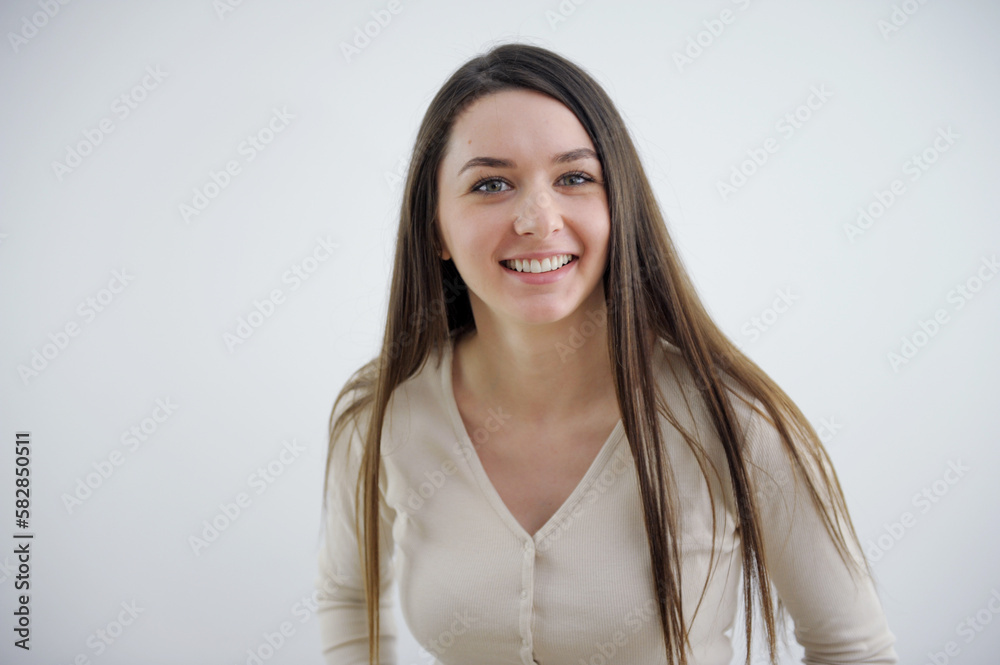 sincere smile of young European woman Ukrainian laughter joy sparkle in her eyes on a white background a cute girl with long hair looks into the frame sincere smile of young European woman Ukrainian laughter joy sparkle in her eyes on a white background a cute girl with long hair looks into the frame