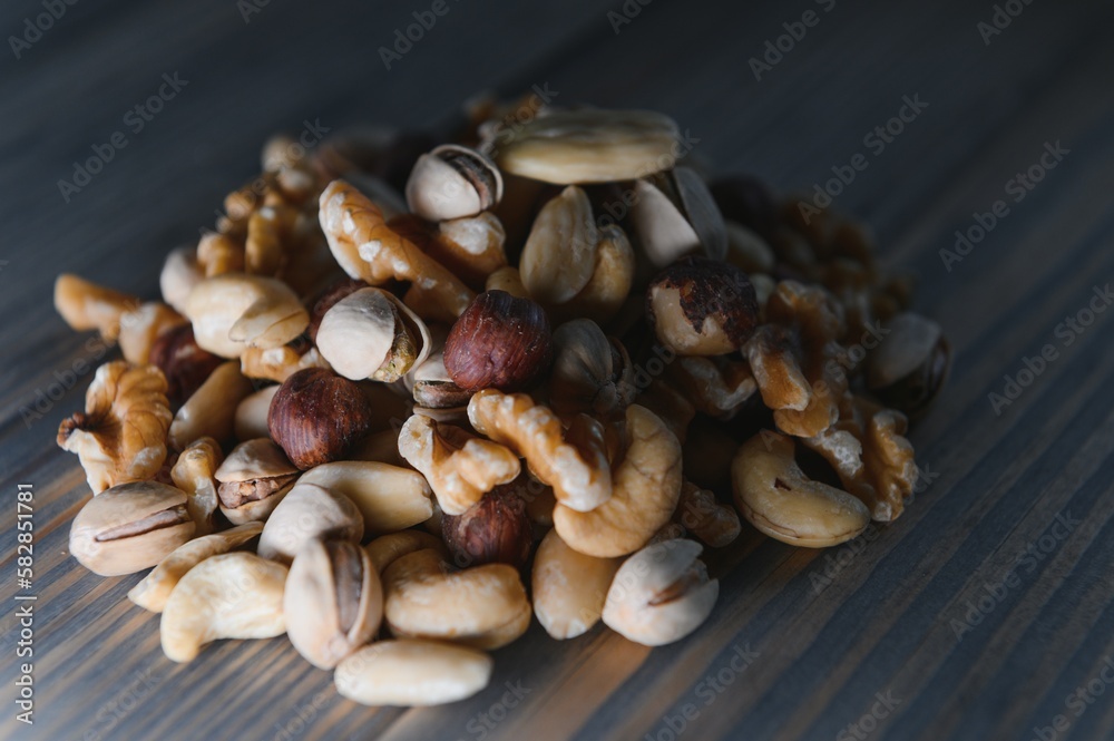 Mixed nuts on wood floor. Organic and fresh nuts. Copy space