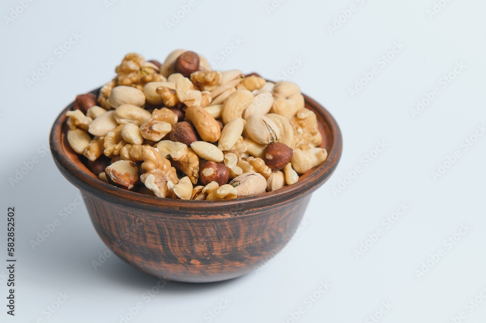 Mixed nuts on a plate. White background Mixed nuts on a plate. White background