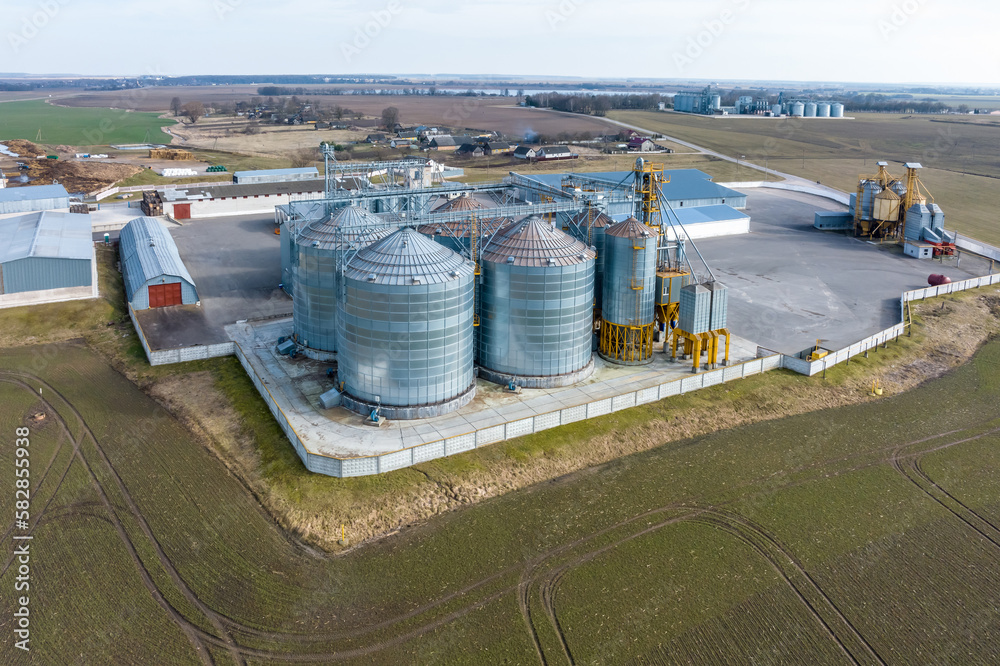 aerial view of agro-industrial complex with silos and grain drying line aerial view of agro-industrial complex with silos and grain drying line