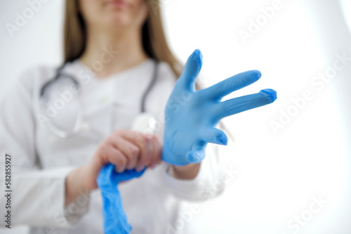 doctor or nurse wearing protective rubber gloves on white background with copy space. Health care concept. High quality photo