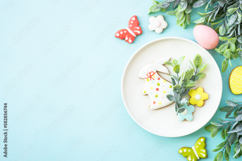 Easter food background. White plate with eggs, spring flowers and easter cookies. Flat lay. Easter food background. White plate with eggs, spring flowers and easter cookies. Flat lay.