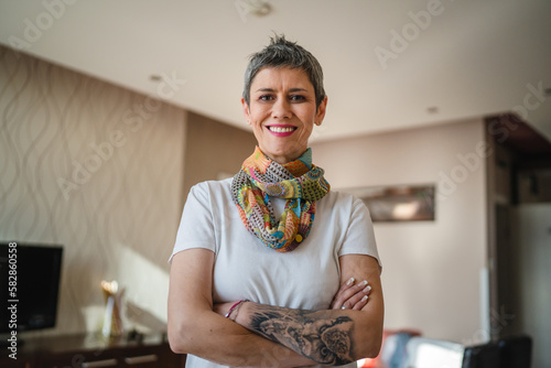 Portrait of one mature senior woman stand alone in apartment at home
