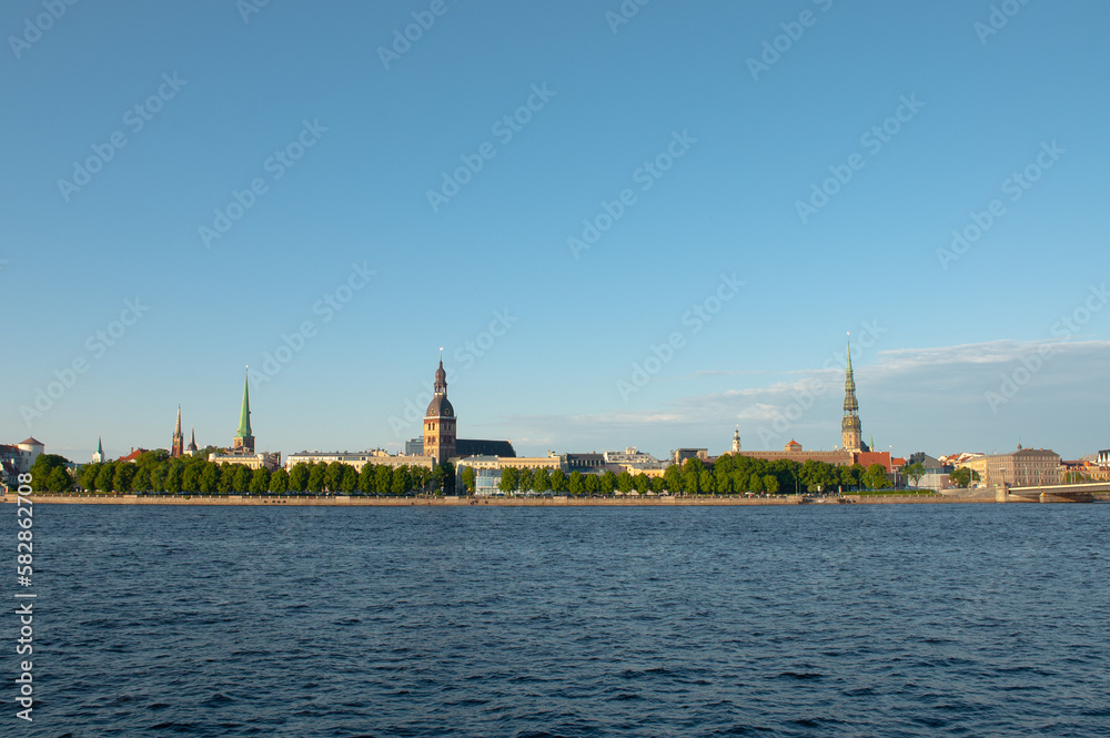 Riga. in the photo, the panorama of the city of Riga, the river in the foreground, the blue sky in the background