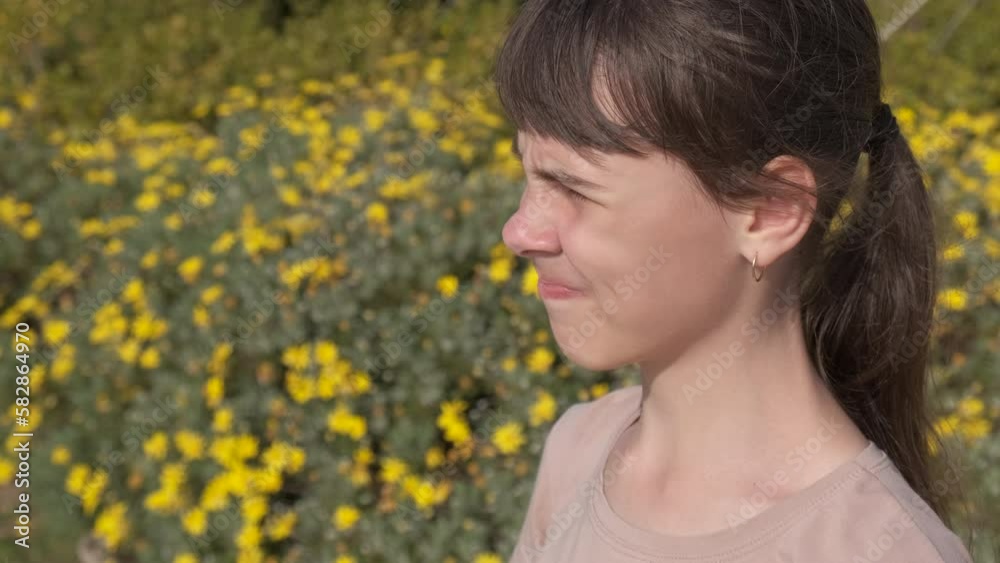 Sneezing from pollen. A teenage girl sneezes from pollen. seasonal discomfort. Sneezing from pollen. A teenage girl sneezes from pollen. seasonal discomfort.