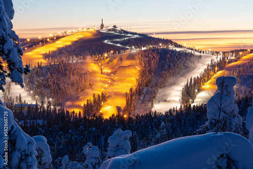 A high angle view to Ruka ski resort slopes on a late winter evening near Kuusamo, Northern Finland photo