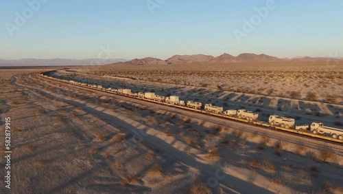 Aerial view driving through the gobi desert. Freight train transporting military equipment to China. Transmongol Railway. photo