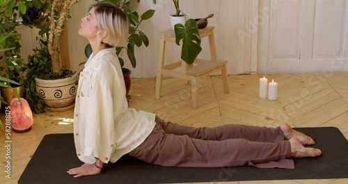 young slim girl performing upward facing dog pose, side view slow motion, female lengthens and strengthens the spine, torso, and arms photo