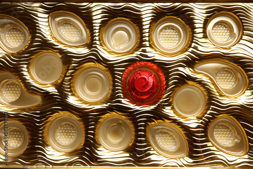 Partially empty box of chocolate candies as background  top view