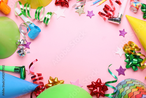 Frame of different accessories for birthday party on pink background, flat lay. Space for text