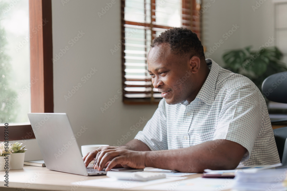 American African Businessman research and analysis with financial graph at office. Strategy, chart, finance report concept American African Businessman research and analysis with financial graph at office. Strategy, chart, finance report concept