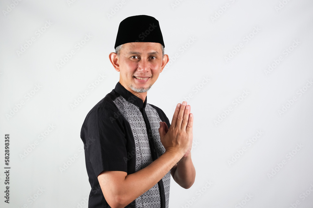 Portrait Asian Moslem Man with greetings and welcoming gestures, smiling face
Portrait Asian Moslem Man with greetings and welcoming gestures, smiling face