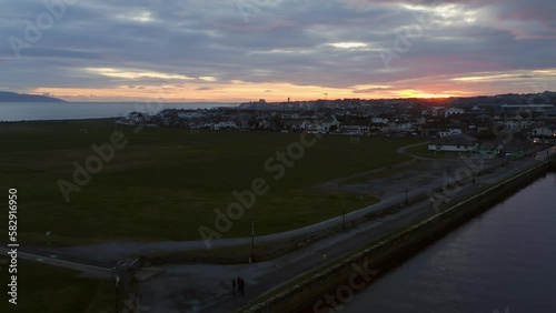 Rising aerial over sunrise on south park and Nimmo's pier as sun begins to cast golden glow over Claddagh Galway Ireland photo