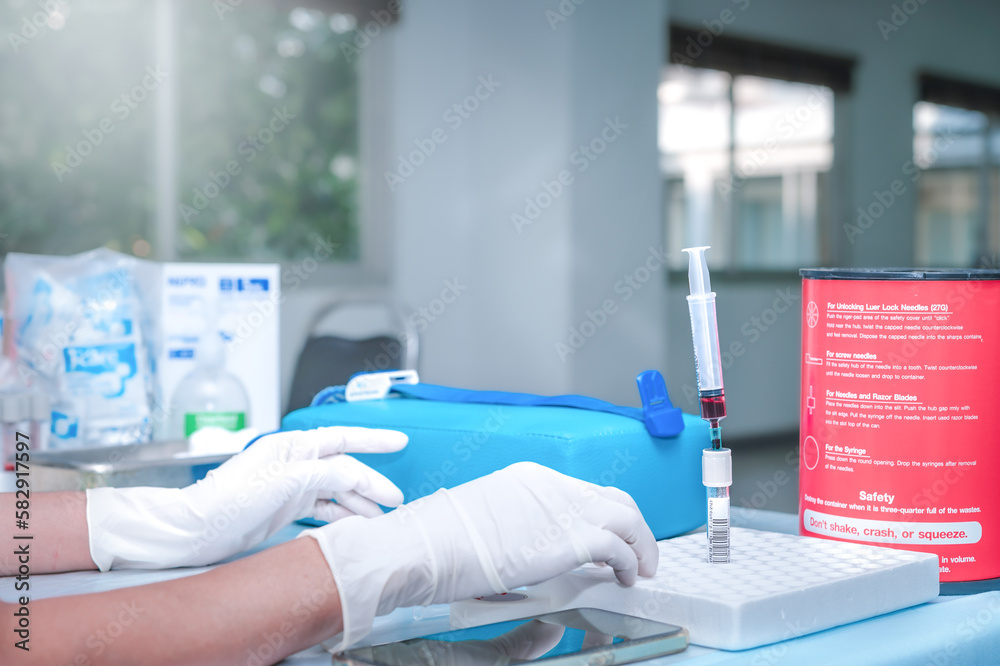 Close up Hand of nurse, doctor or Medical technologist in gloves taking blood sample from a patient in the hospital. Close up Hand of nurse, doctor or Medical technologist in gloves taking blood sample from a patient in the hospital.