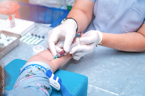 Close up Hand of nurse  doctor or Medical technologist in gloves taking blood sample from a patient in the hospital.