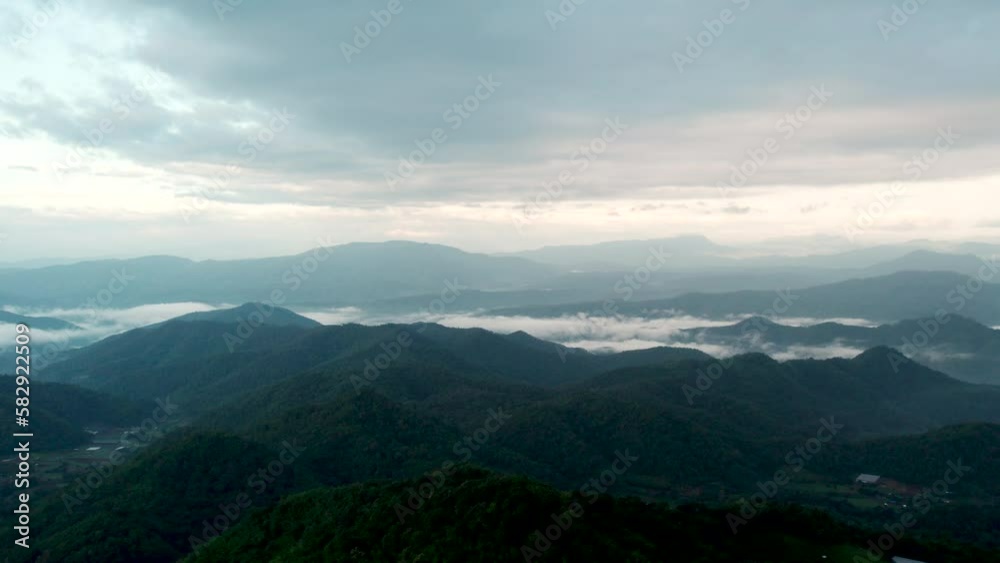 Top view Landscape of Morning Mist with Mountain Layer at north of Thailand. mountain ridge and clouds in rural jungle bush forest Top view Landscape of Morning Mist with Mountain Layer at north of Thailand. mountain ridge and clouds in rural jungle bush forest