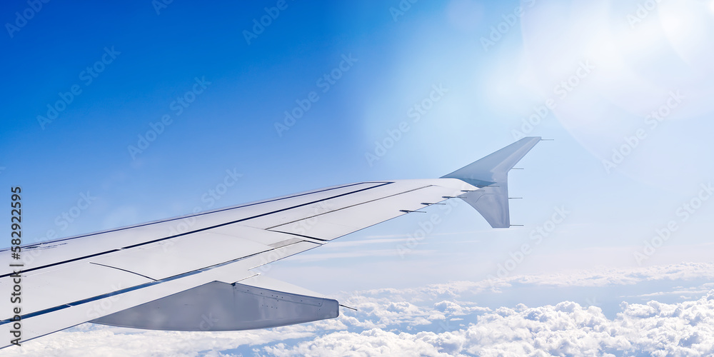 Fototapeta premium Wing aircraft in altitude during flight. clear sky in sunny day. travel concept