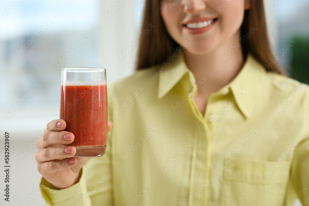 Beautiful young woman with delicious smoothie on blurred background, closeup Beautiful young woman with delicious smoothie on blurred background, closeup