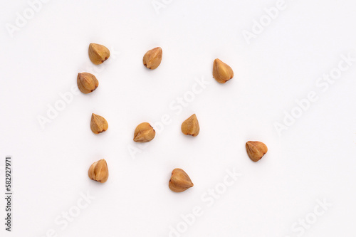 Close-up, macro of buckwheat on a white background.Hypoallergenic pillow filling. Prevention of anemia.