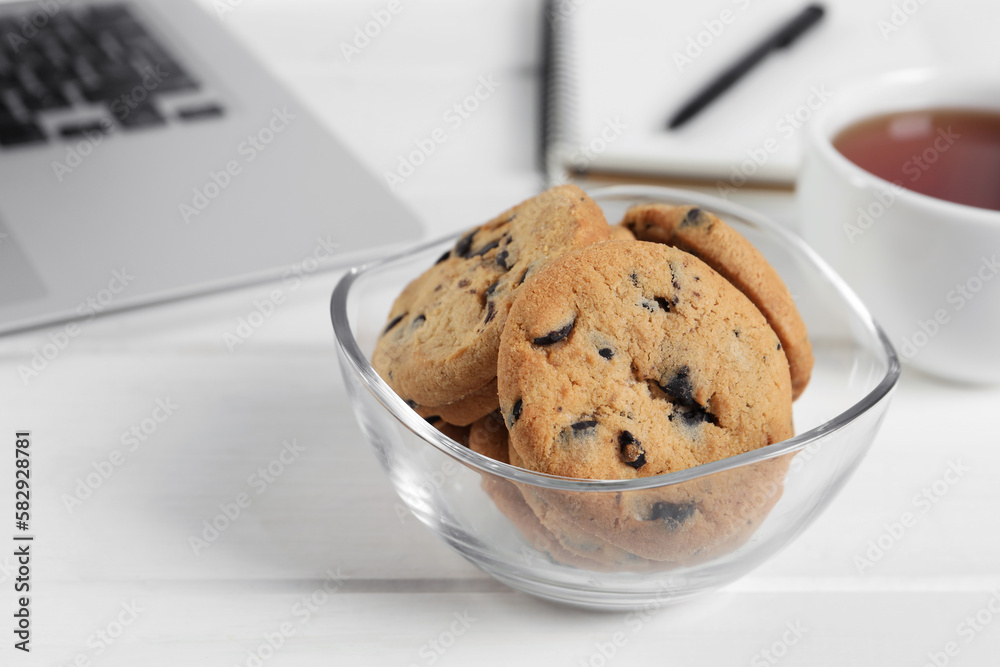 Chocolate chip cookies on white wooden table in office, closeup Chocolate chip cookies on white wooden table in office, closeup