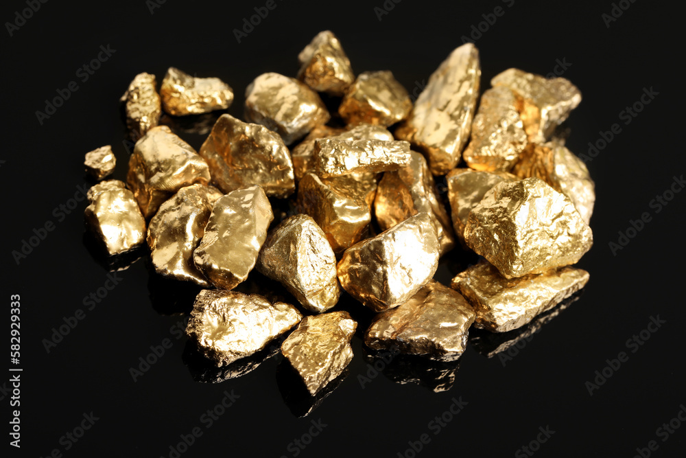 Pile of shiny gold nuggets on black background Pile of shiny gold nuggets on black background