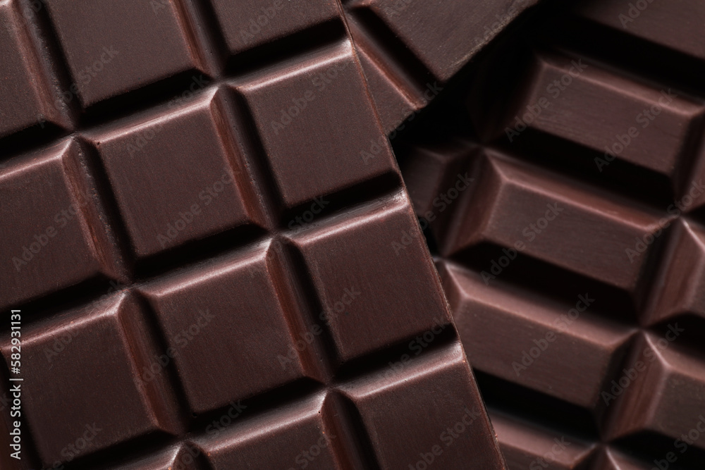 Many delicious dark chocolate bars as background, top view Many delicious dark chocolate bars as background, top view