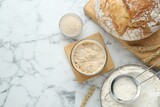 Flat lay composition with sourdough on white marble table. Space for text