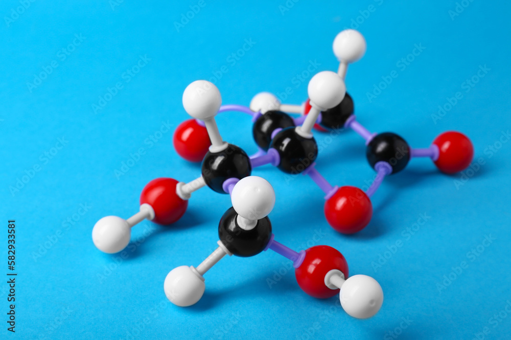 Molecule of vitamin C on light blue background. Chemical model Molecule of vitamin C on light blue background. Chemical model