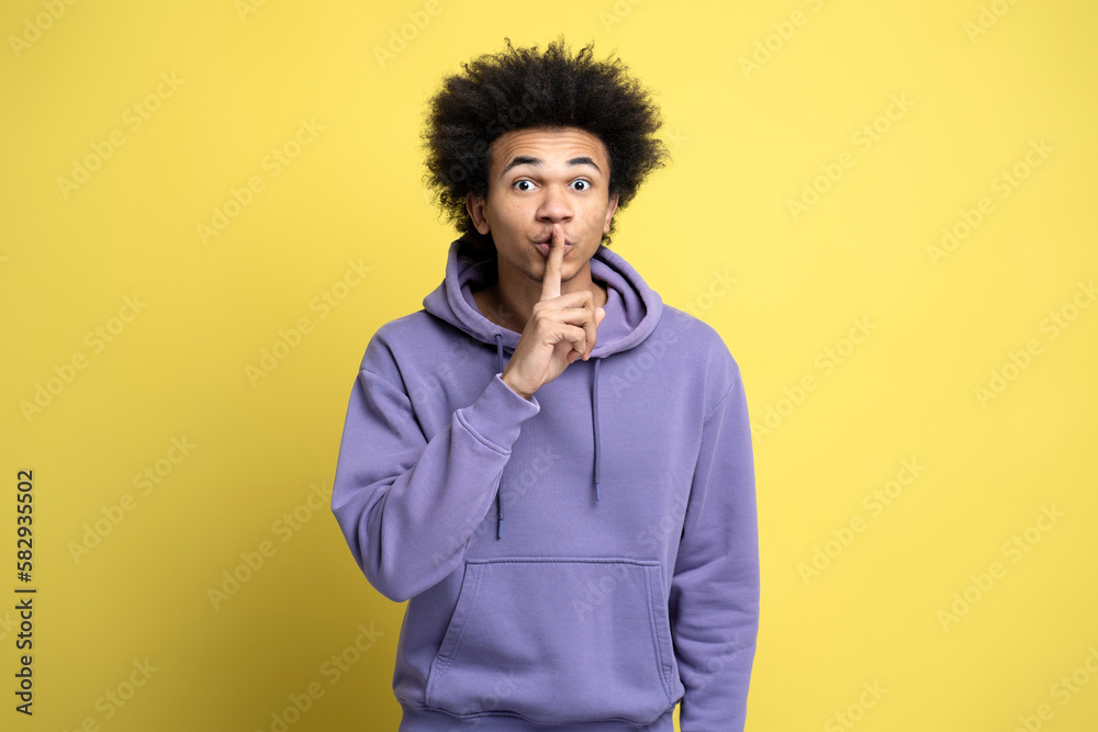 African American man showing hush with finger on lips gesture African American man showing hush with finger on lips gesture