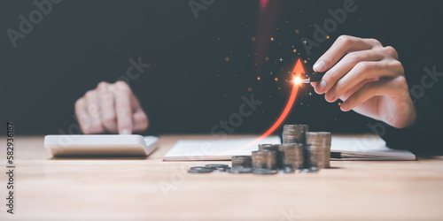 accountant holding a pen ,arrow shows interest rate growth and profitability ,investment growth percentage and interest on deposits ,an increase in interest rates ,Financial concept ,interest burden