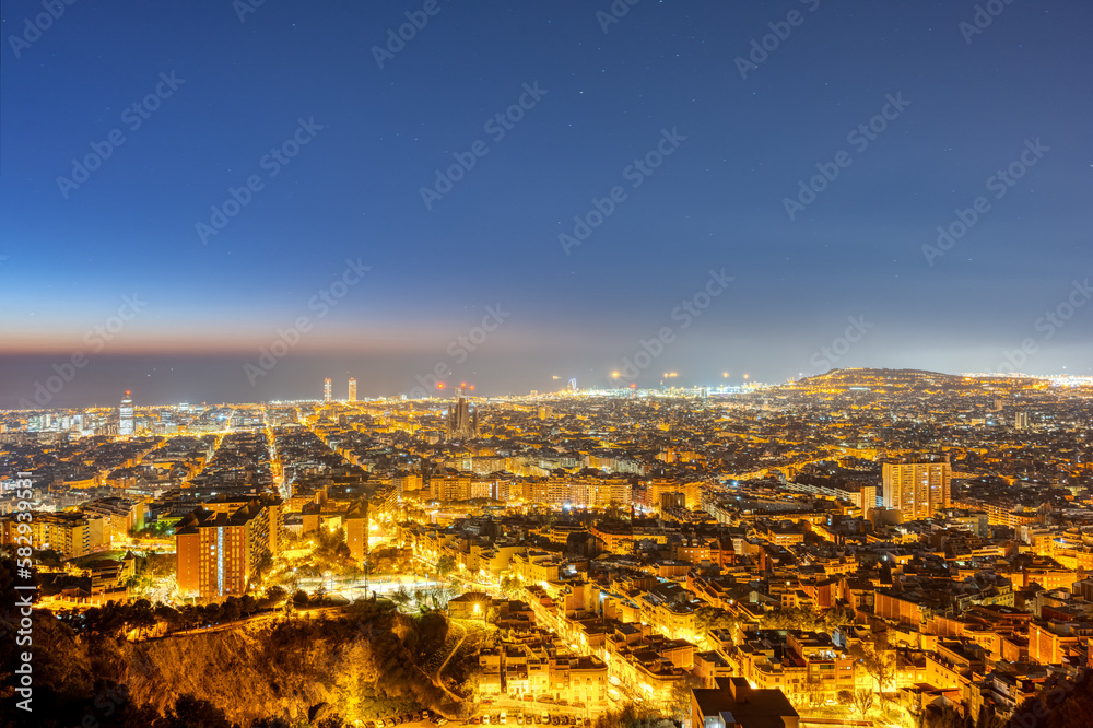 The skyline of Barcelona with the Mediterranean Sea in the back at night