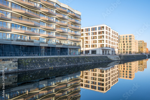 Modern apartment buildings in Berlin with a reflection in a small canal